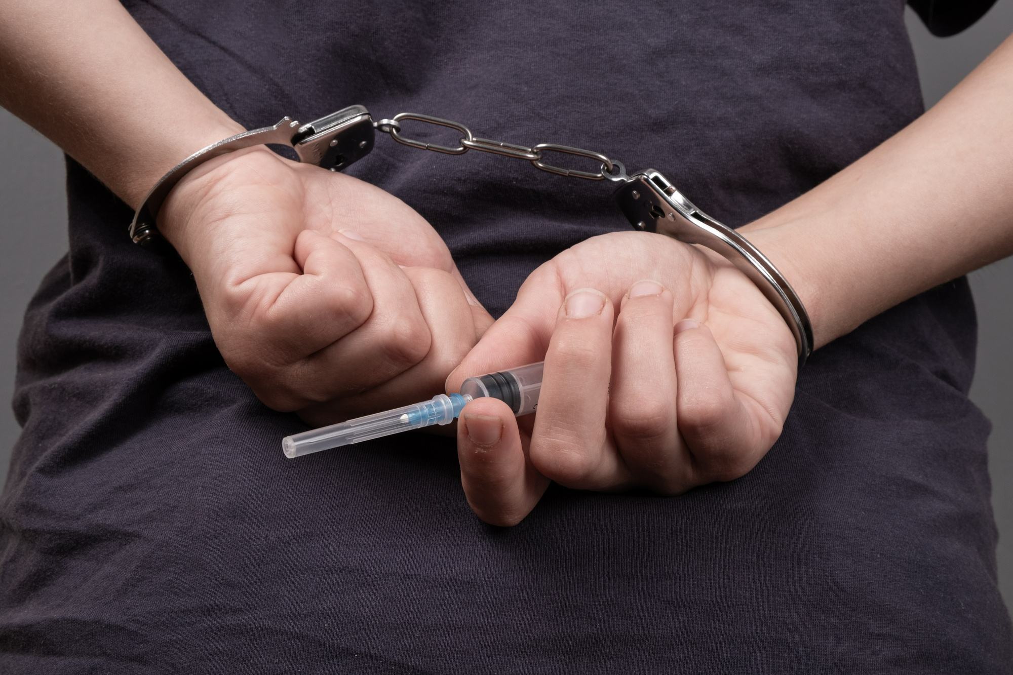 drug-trafficking-man-handcuffs-with-syringe